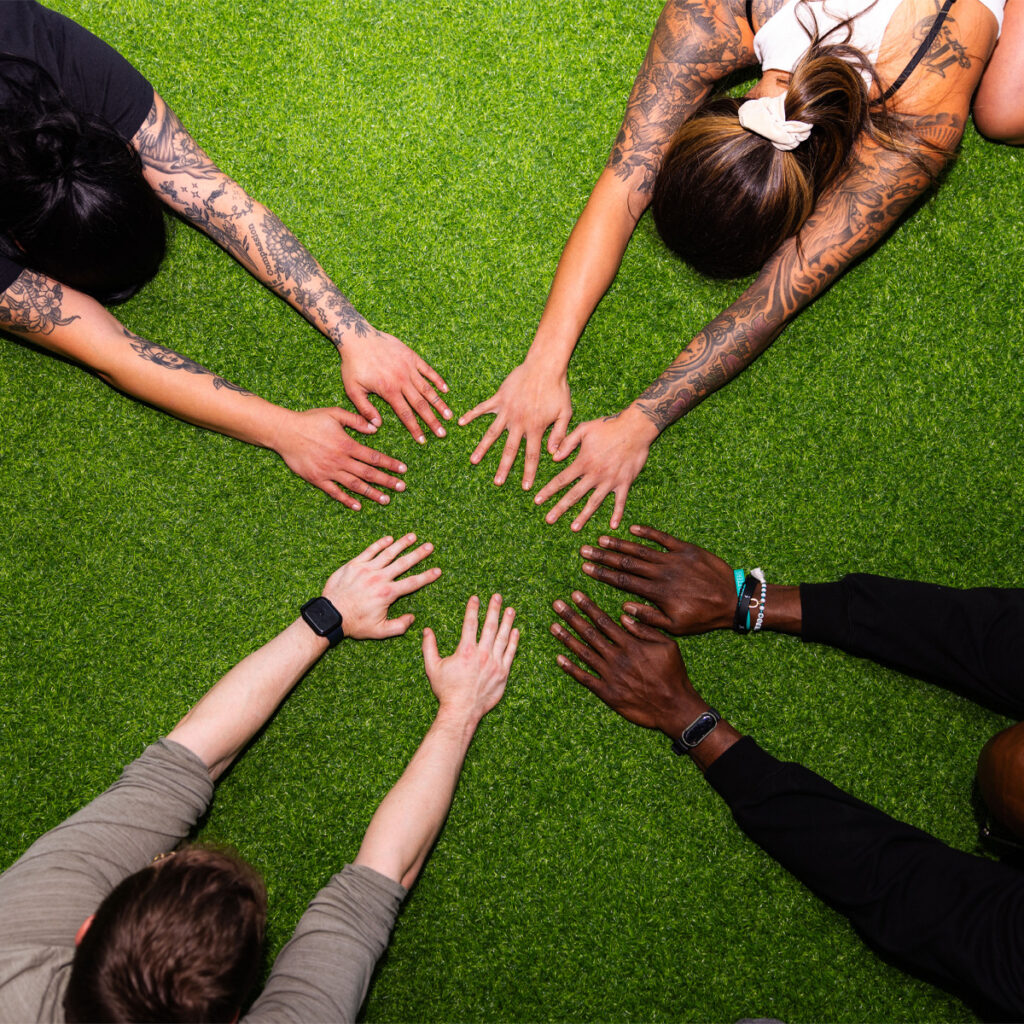 Dan and Mike stretching with two women at eFIT